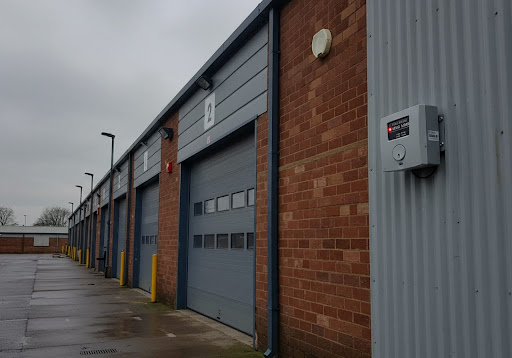 A commercial intruder alarm installed on the side of a distribution centre.